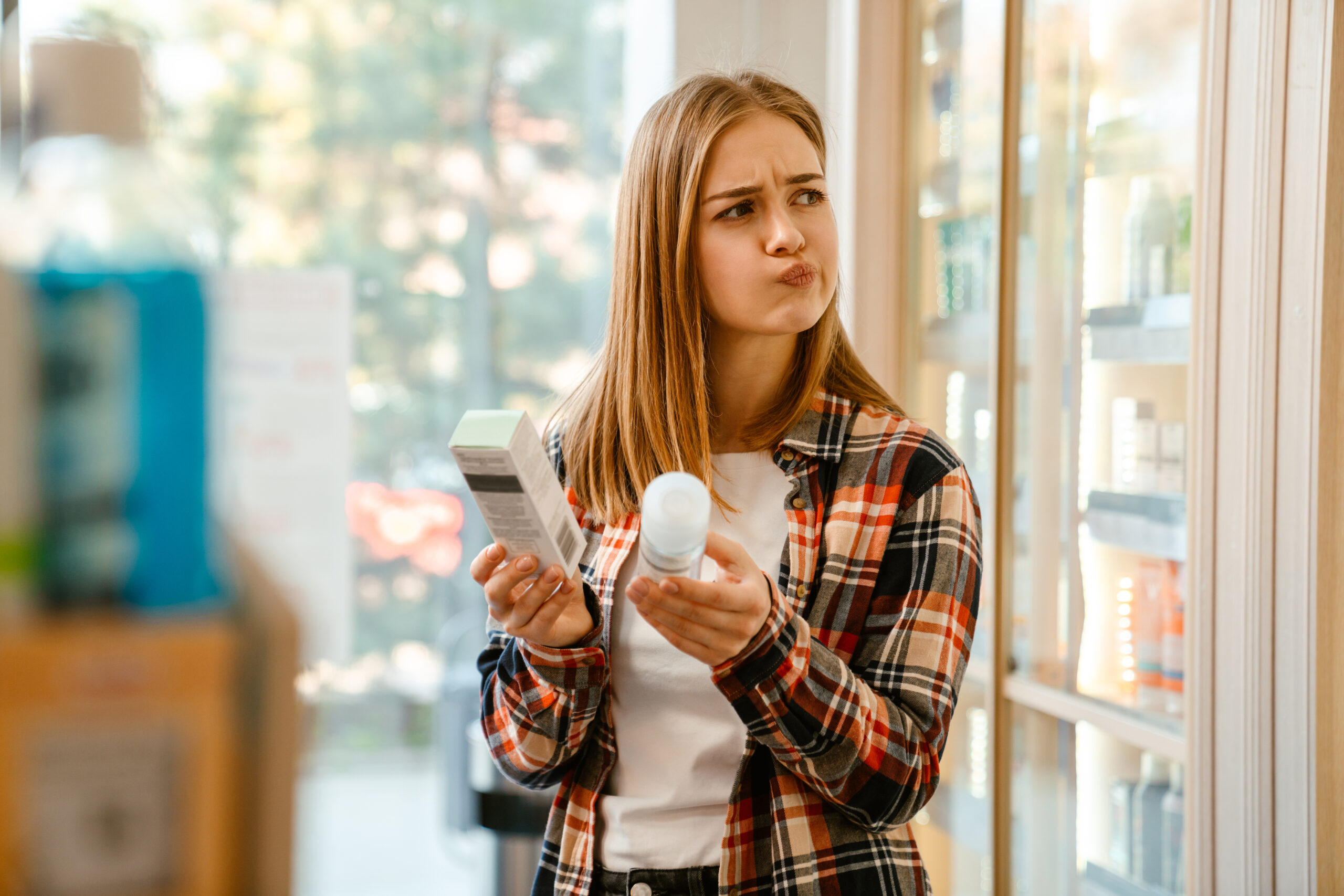 Woman choosing 2% vs 5% minoxidil