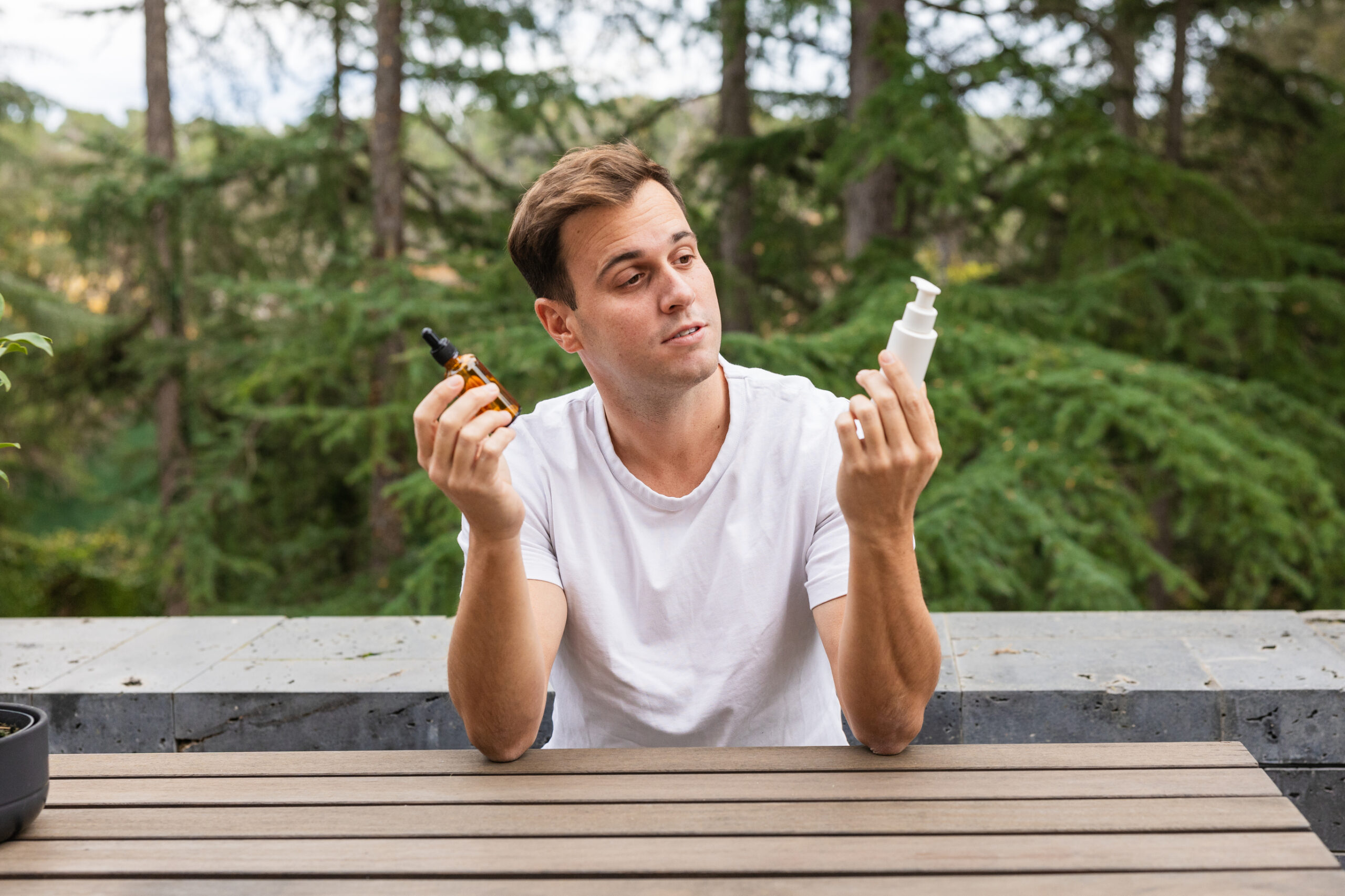 Man choosing between minoxidil formulations